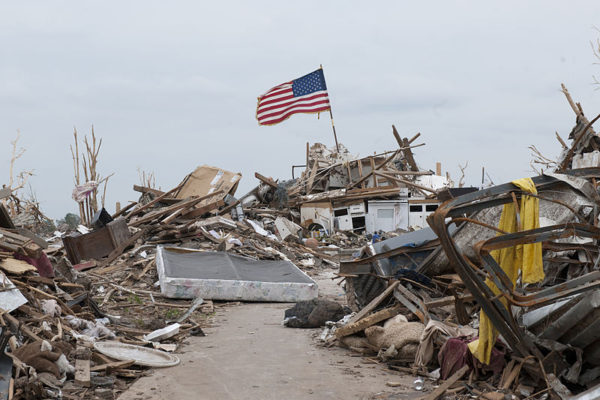 800px-Tornado_aftermath_can_be_seen_in_Moore,_Okla.,_May_28,_2013_130528-Z-TK779-007 An american flag stands above a destroyed homestead, storm shelters save lives.