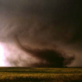 A dust tornado is tearing through the plains of oklahoma.