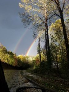 A double rainbow streaks across the sky after the storm.