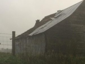 Barn roof torn off in the rain.